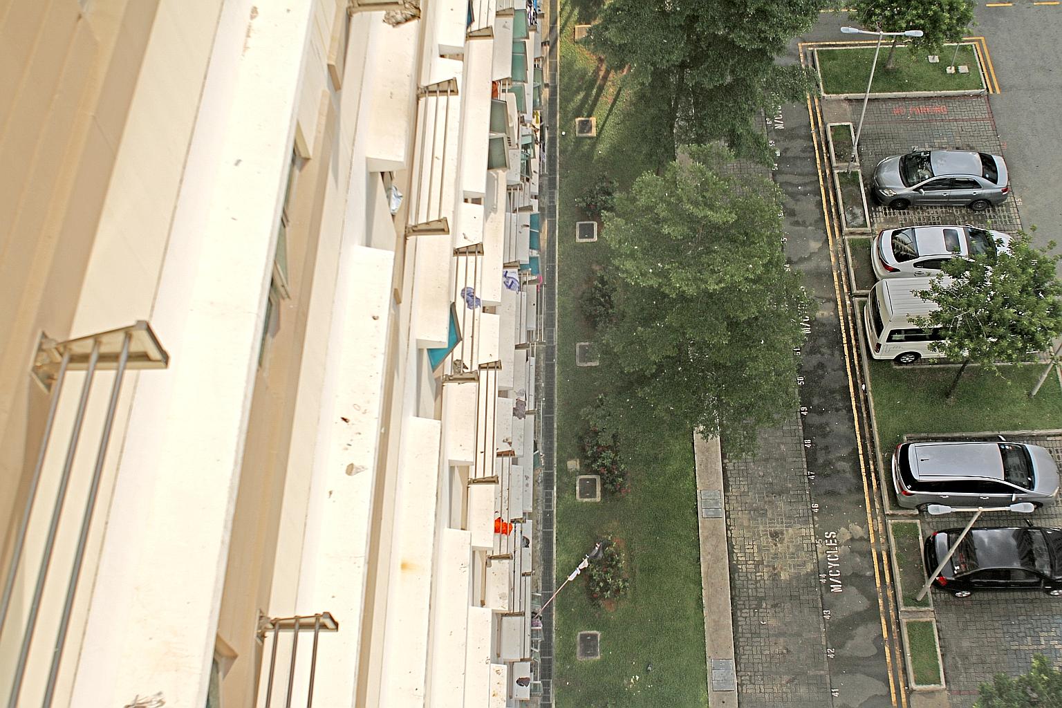 A two-year-old boy fell 11 storeys from a unit at Block 182A Rivervale Crescent (left) on Sunday. Residents (above) found him lying on a grass patch at the foot of the block. His injuries were mainly to the left side of his body, says general practit