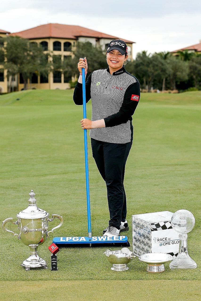 Above: Thailand's Moriya Jutanugarn. Left: Her sister, world No. 1 Ariya, posing with the "LPGA Sweep". From left: The Rolex Player of the Year trophy, Leaders Top 10 Competition Trophy, Vare trophy, Rolex Annika Major award and the Race to the CME G