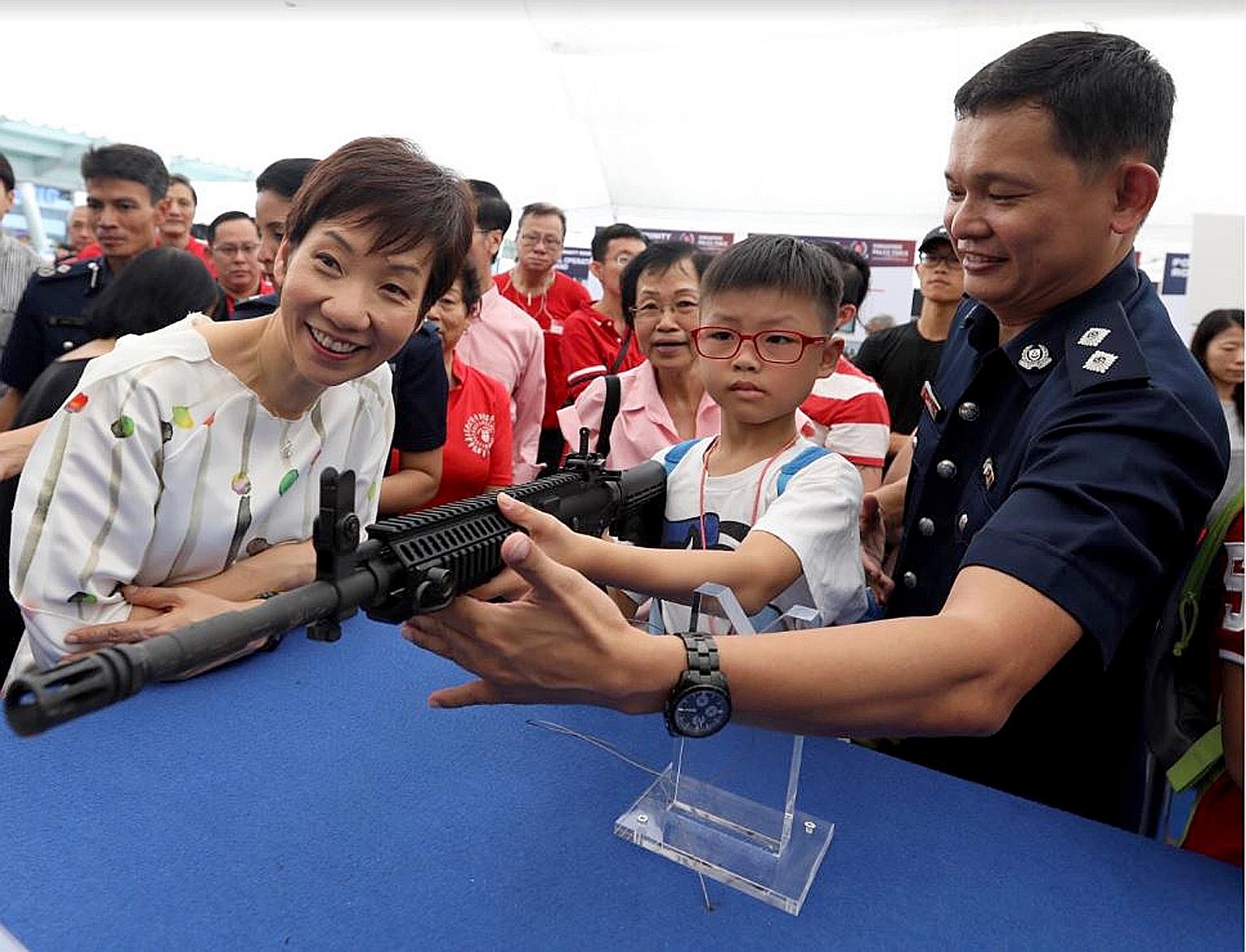 Minister for Culture, Community and Youth Grace Fu visiting a police community roadshow in Jurong East yesterday. She said the Police Coast Guard has been made even busier patrolling Singapore's waters recently because Malaysian vessels have started 