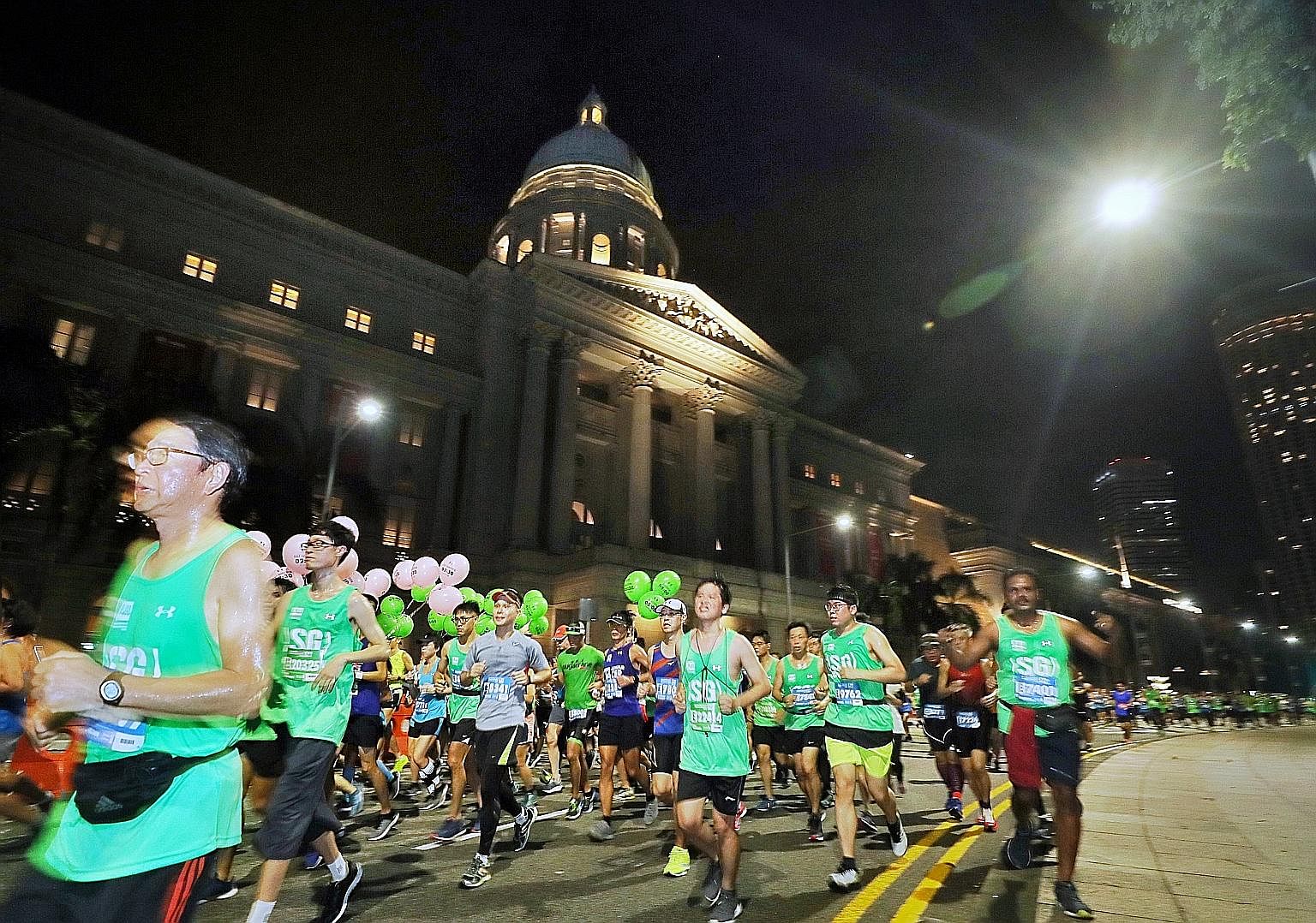 Runners made their way past the National Gallery yesterday as the city centre came alive at dawn with more than 30,000 enthusiasts pounding the streets during the Standard Chartered Singapore Marathon. The event, now into its 17th edition, attracted 