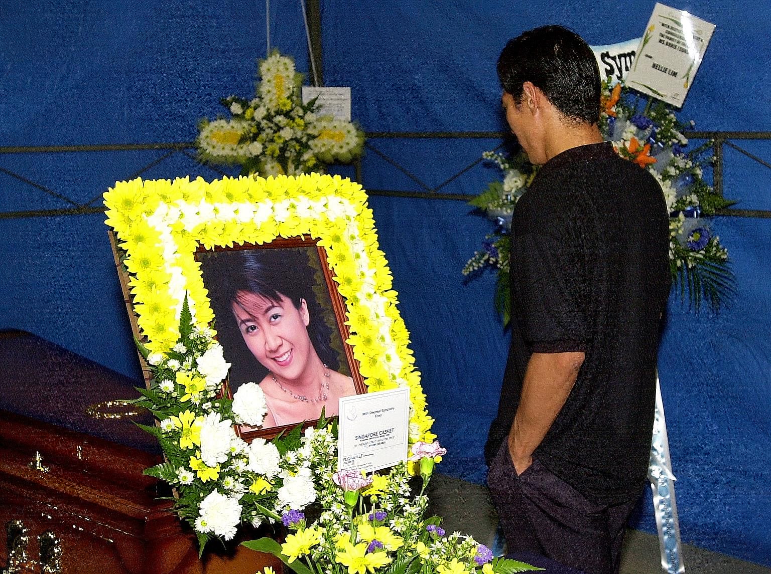Left: The then 15-year-old, who killed Ms Annie Leong at the behest of her estranged husband Anthony Ler (above), leaving the High Court in November 2001. Below: Ler at Ms Leong's wake. He was hanged in December 2002 for abetment of murder.