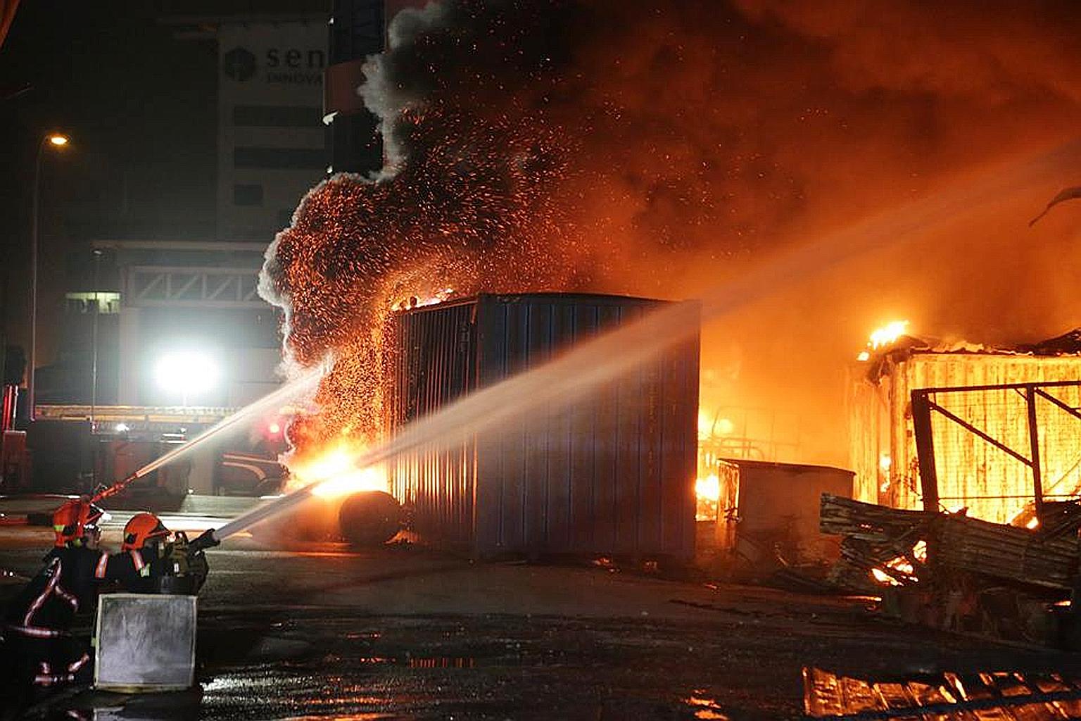 SCDF firefighters battling a blaze at 31 Sungei Kadut Street 2 in the early hours of yesterday morning. At the height of operations, 12 water jets were used to bring the fire under control.