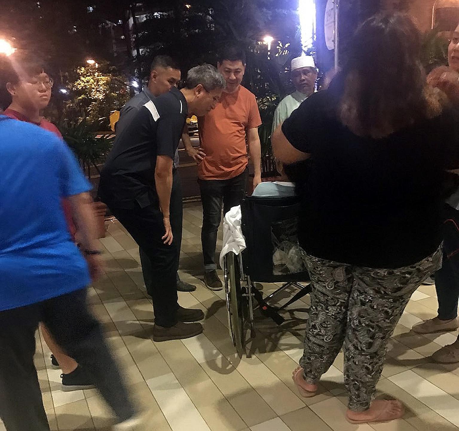 SMRT chief executive officer Neo Kian Hong (in black) talking to one of the injured employees at the Khoo Teck Puat Hospital's accident and emergency ward last night.