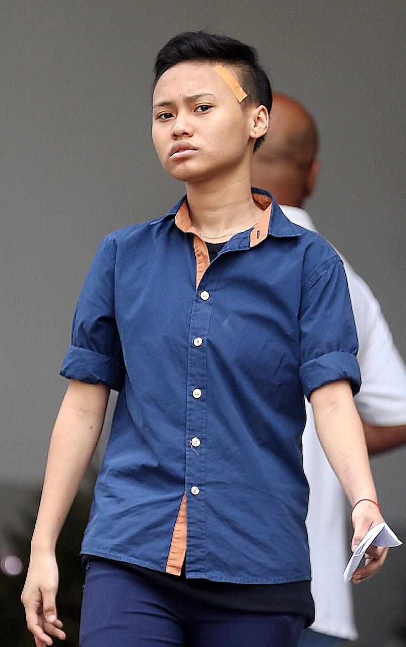 Nur Qairulnisha Rosmani, one of the three accused of buying items with counterfeit $100 notes to obtain change in real currencies.