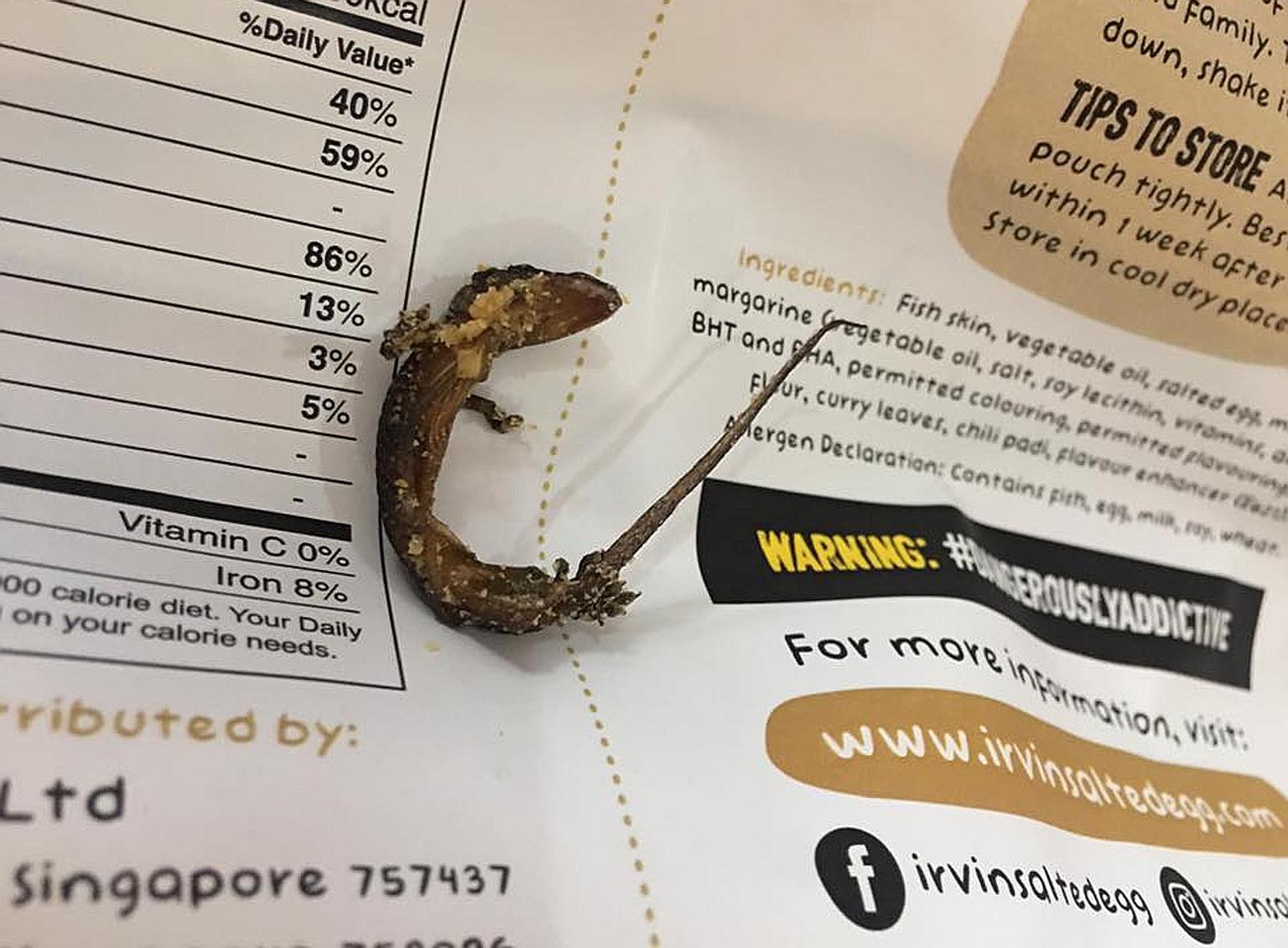 Ms Jane Holloway bought the snack in Bangkok in early November. Her brother initially thought the dead lizard was a baby salmon fish head. Irvins Salted Egg issued an apology yesterday. The Singapore-based food company is offering refunds for certain