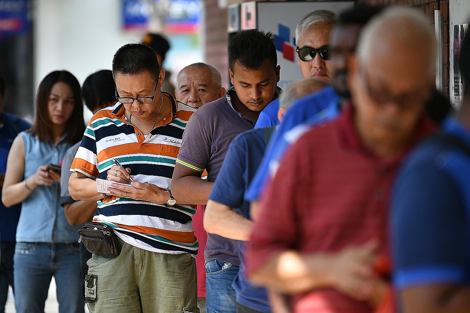 Punters queueing up to buy Toto tickets at the 7-Eleven outlet at Block 102 Yishun Avenue 5 yesterday. Last night, a single punter won the Group 1 cascade draw prize of $9,731,377. The winning ticket was sold at FairPrice Changi Business Park Hyperma