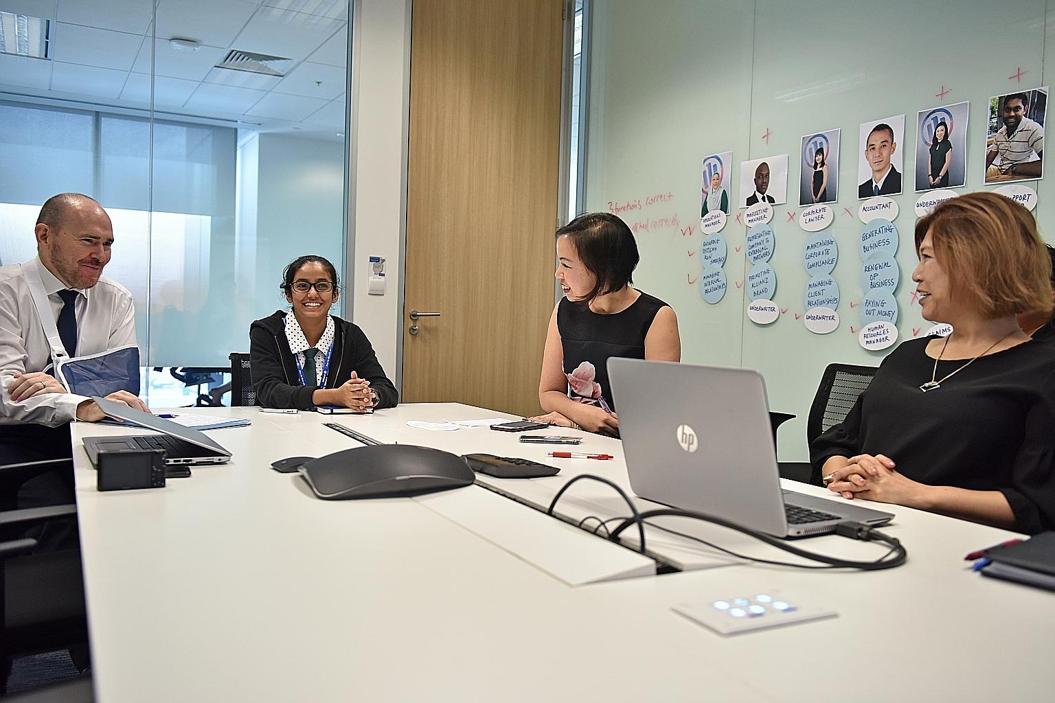 Sec 4 student Jaburooth Rakshana with Mr Mark Mitchell, Allianz Global Corporate and Specialty's (AGCS) regional CEO for Asia-Pacific, whose office she took over for the day. With them are Ms Irene Yeo (at far right), regional head of planning and pe