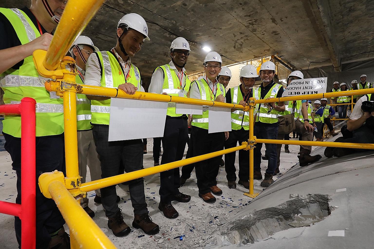 From far left: Senior Parliamentary Secretary for Transport Baey Yam Keng, Senior Minister of State for Transport Janil Puthucheary and Mountbatten MP Lim Biow Chuan at the Katong Park MRT station work site yesterday. Dr Janil broke through a tunnel 