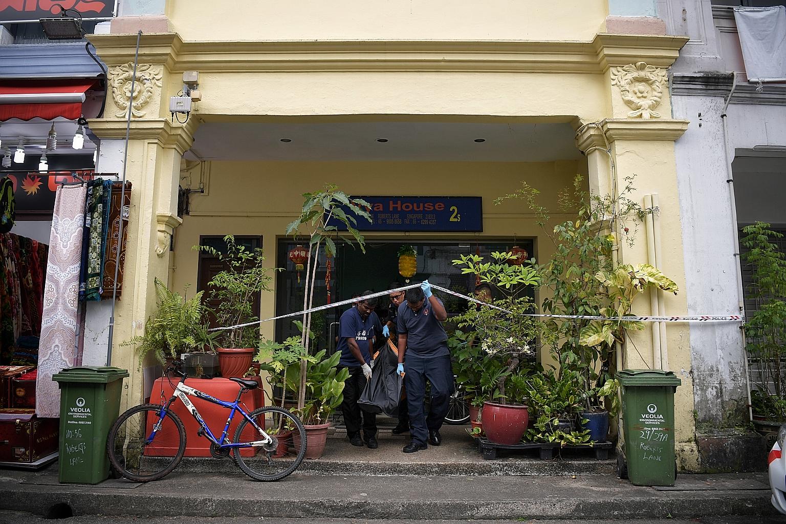 The body of a 33-year-old woman being removed from the Vya House hostel in Roberts Lane yesterday.