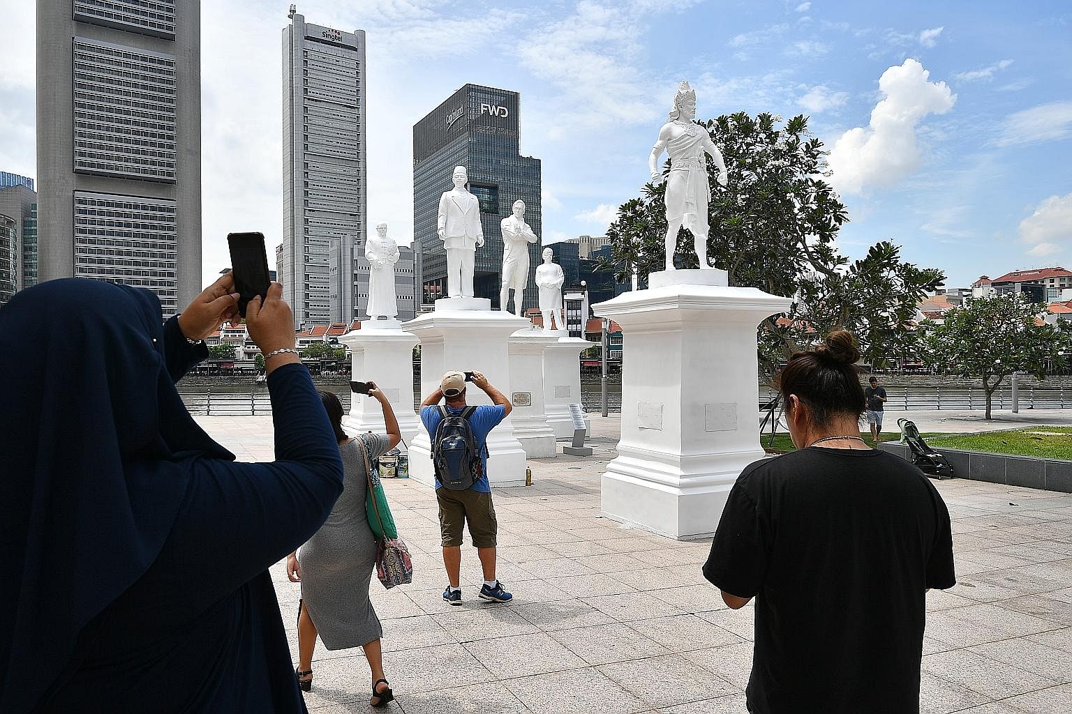 The statue of Sir Stamford Raffles (centre) by the Singapore River has been joined by (from left) community leader Tan Tock Seng, Raffles' secretary and interpreter Munshi Abdullah, treasury chief clerk Naraina Pillai and Sang Nila Utama.