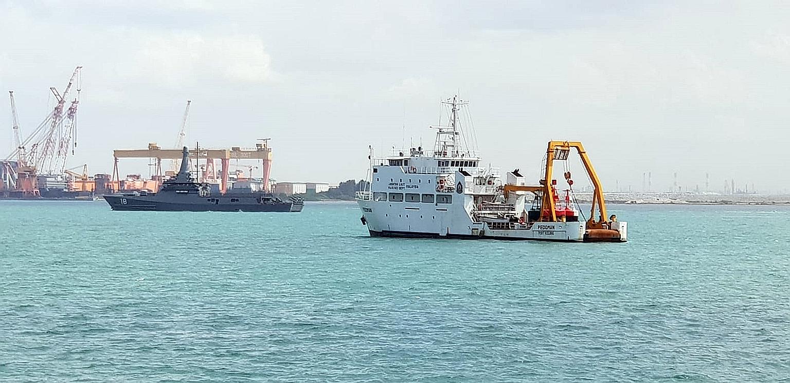 Republic of Singapore Navy's littoral mission vessel RSS Justice (left) near the Malaysian Marine Department vessel Pedoman anchored within Singapore port limits. The Republic's security agencies have been ordered to avoid escalating tensions for now