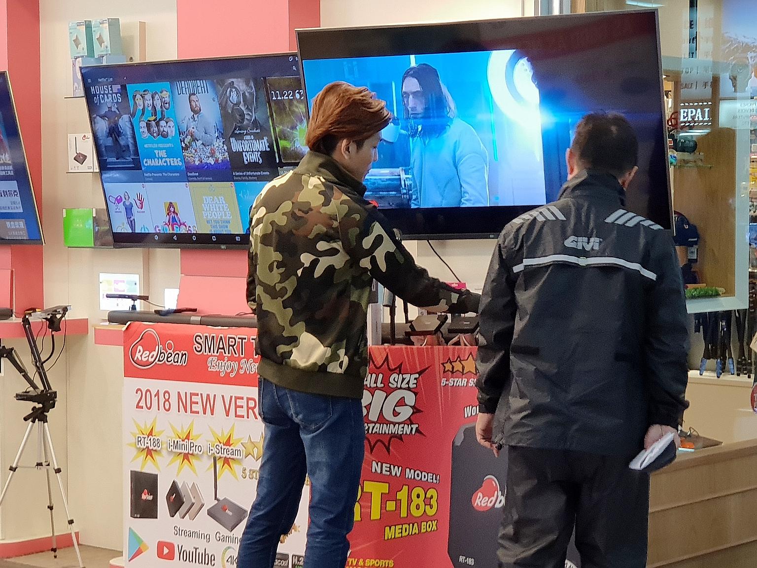 Streaming set-top boxes, which help consumers access pirated content, are openly promoted and sold at shops at Sim Lim Square. New laws to be tabled this year will ban the sale of such boxes.