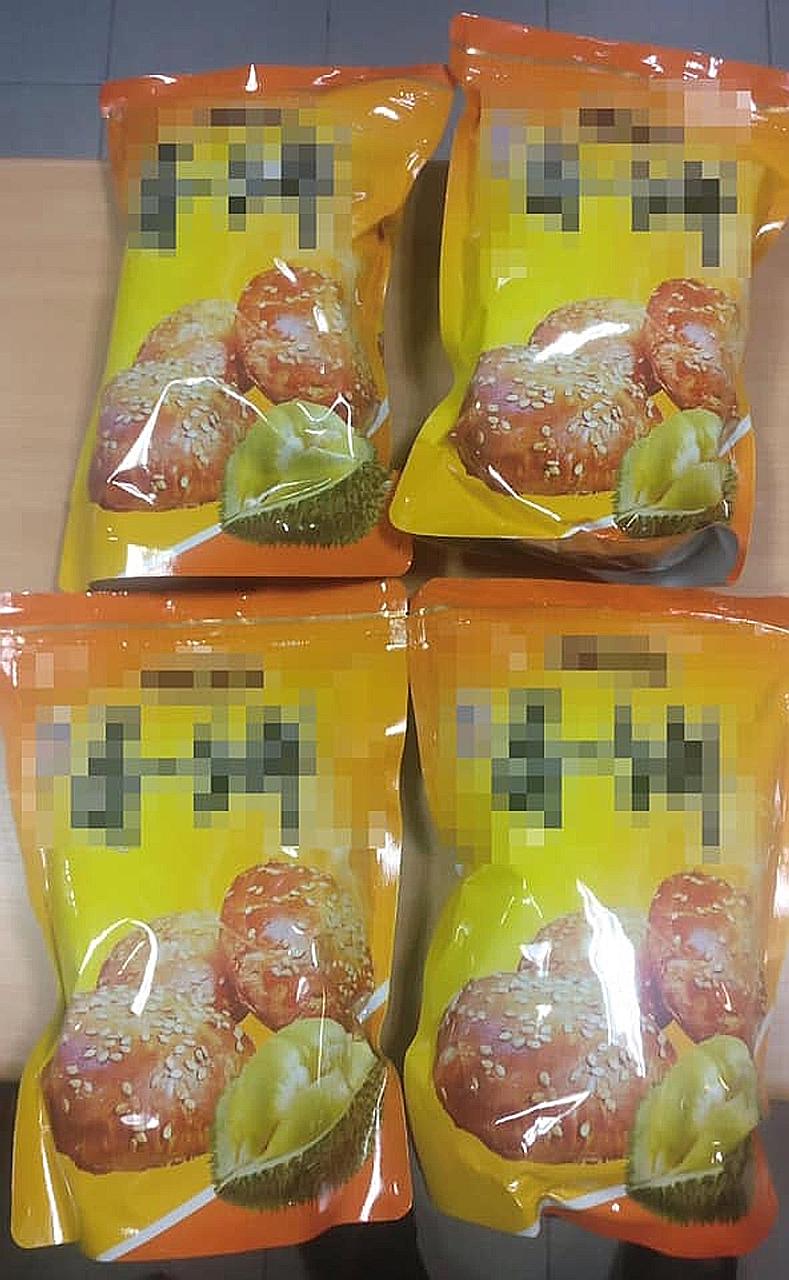ICA officers caught two Singaporeans who tried to bring in bak kwa from Malaysia by hiding the meat product in packets of durian-flavoured biscuits.