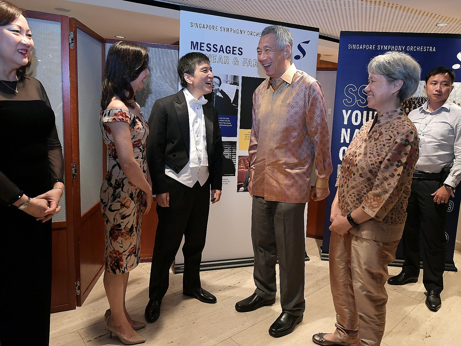 Prime Minister Lee Hsien Loong and Mrs Lee chatting with Singapore Symphony Orchestra music director Lan Shui and his wife Liu Lin Lin at the Esplanade last night. With them is SSO founding member Lynnette Seah.
