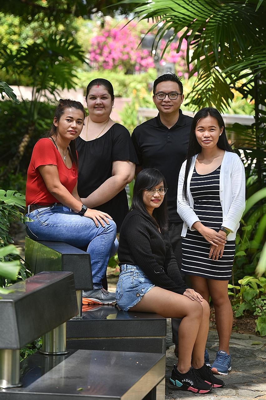 (From left) Indonesian maid Idah Rosidah, 34, Ms Sunita Shri Rammani, 40, an employer, Indonesian maid Nurlaela (sitting), 25, employment agent Ierfan Ibrahim from Living Well Maid Agency, 36, and Filipino maid Janelyn Dupingay Vergara, 28. Ms Sunita