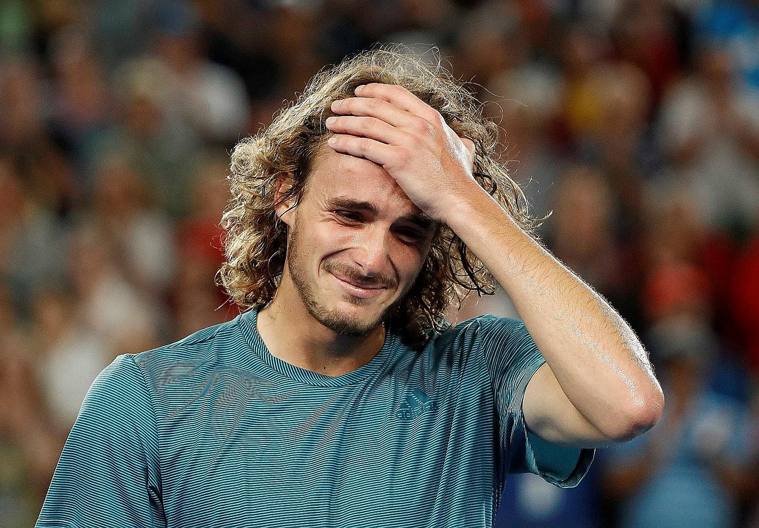 Greece's Stefanos Tsitsipas (left) in disbelief after his shock fourth-round win over defending champion Roger Federer at the Australian Open yesterday.