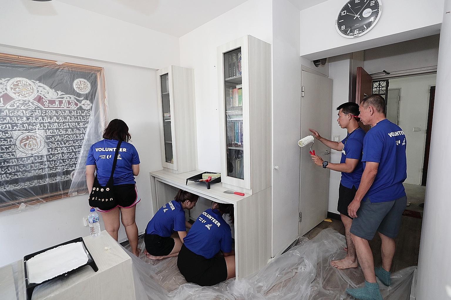 Volunteers at work in the home of a Tampines resident yesterday. It was part of an initiative called Project Refresh, which aims to encourage people of all ages to volunteer.