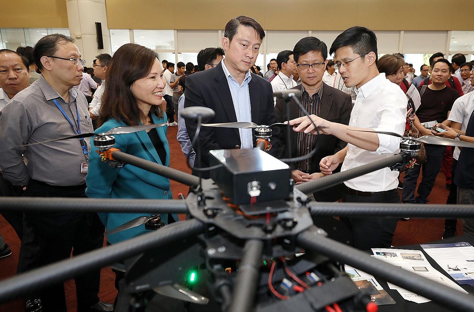 Garuda Robotics chief executive Mark Yong briefing Senior Minister of State for Transport and Health Lam Pin Min (centre), ITE CEO, Ms Low Khah Gek, and Science Centre Singapore CEO, Associate Professor Lim Tit Meng, at the inaugural Drone Technology