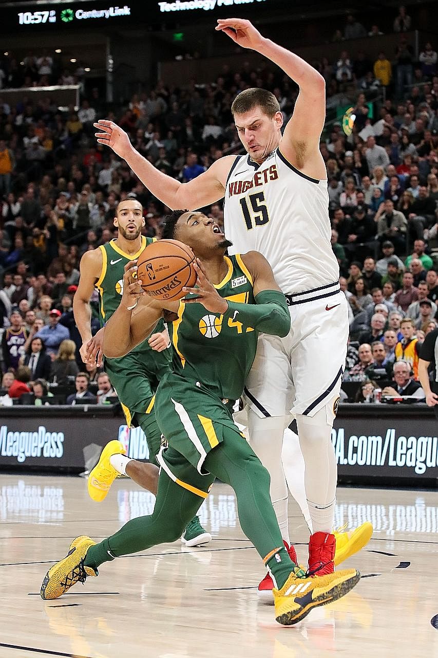 Denver's Nikola Jokic trying to stop Donovan Mitchell as the Nuggets lost 114-108 to hosts Utah Jazz on Wednesday to drop to 31-15. The Serbian centre leads the West's second-best team in points, assists and rebounds.