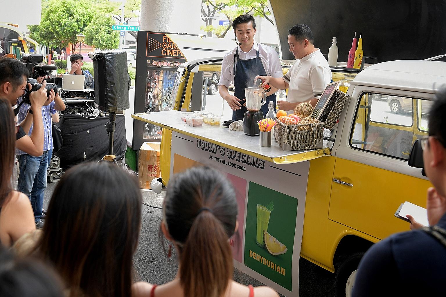 Senior Parliamentary Secretary for Health and Home Affairs Amrin Amin spraying pesticide into a juice concoction to represent the harmful chemicals that are present in innocuous-looking products during a roadshow at Bugis+ mall yesterday.
