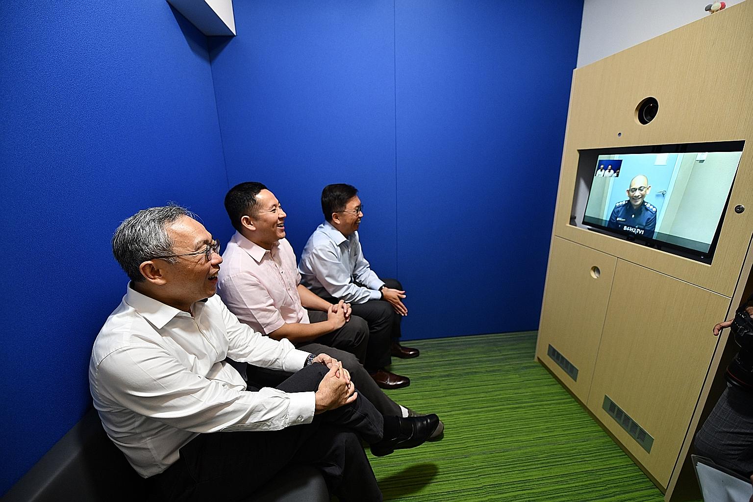 Senior Parliamentary Secretary for Home Affairs Amrin Amin, flanked by Commissioner of Prisons Desmond Chin (foreground) and Industrial and Services Co-Operative Society board chairman Daniel Teo, speaking to Singapore Prison Service Cluster B Superi