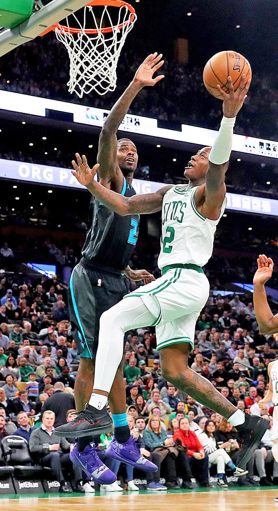 Boston's Terry Rozier (right) taking a shot against Charlotte's Marvin Williams during the second half at Boston's TD Garden home on Wednesday. Rozier scored 17 points to help his team to a 126-94 victory over the Hornets.