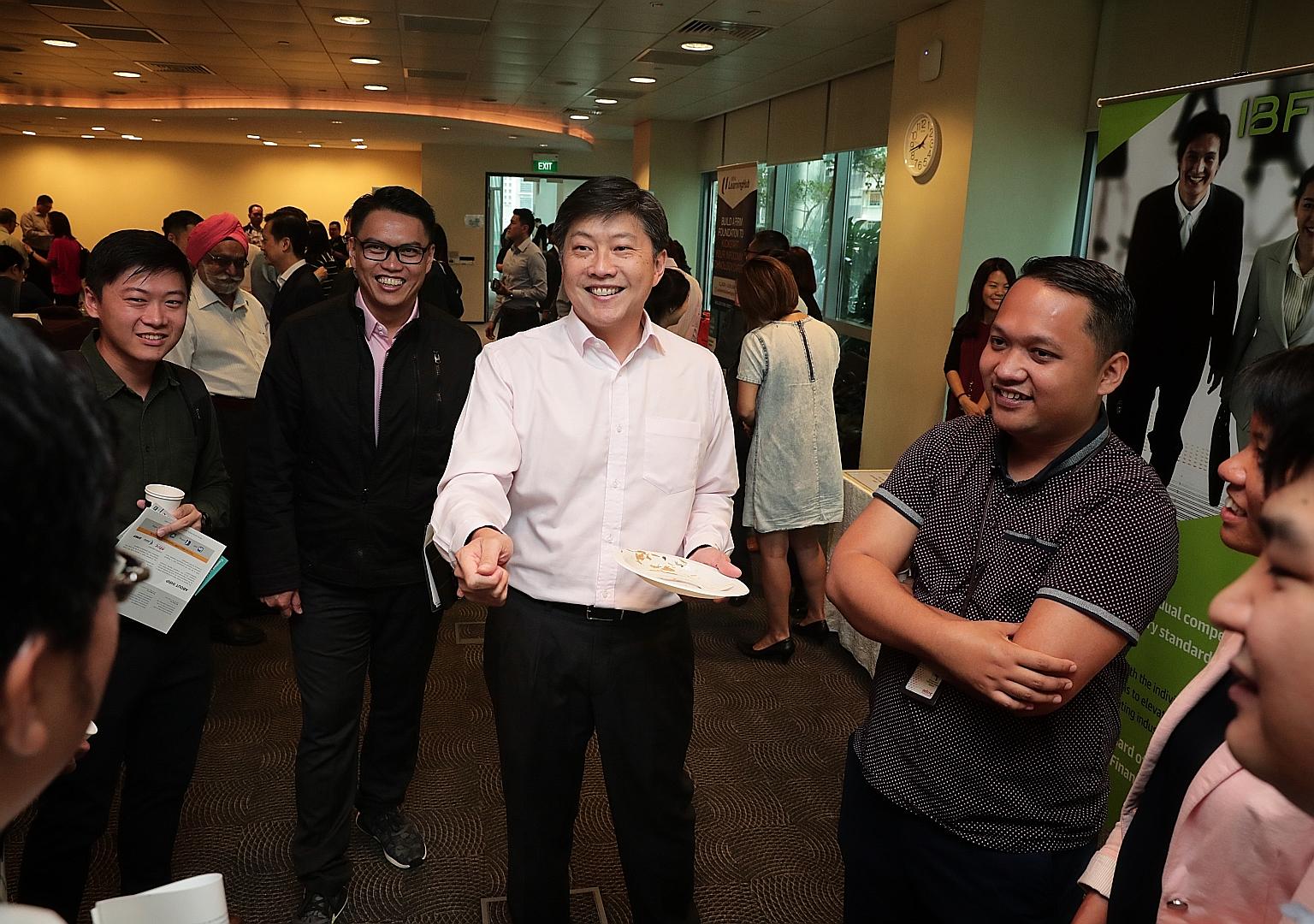NTUC secretary-general Ng Chee Meng (centre) and assistant secretary-general Patrick Tay (in black jacket) before the start of the Future Jobs, Skills and Training Forum yesterday.