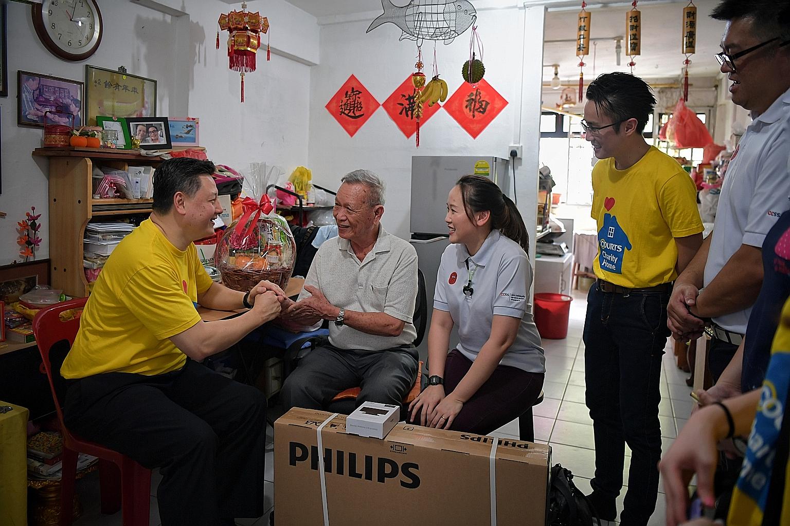 Mr Ben Tan (left), country chief executive officer of Courts Singapore speaking with Mr Ng Ah Ngow, 77, during a home visit on Thursday. With them are Ms Jaena Teo , acting head for the CareElderly programme from Care Community Services Society (CCSS