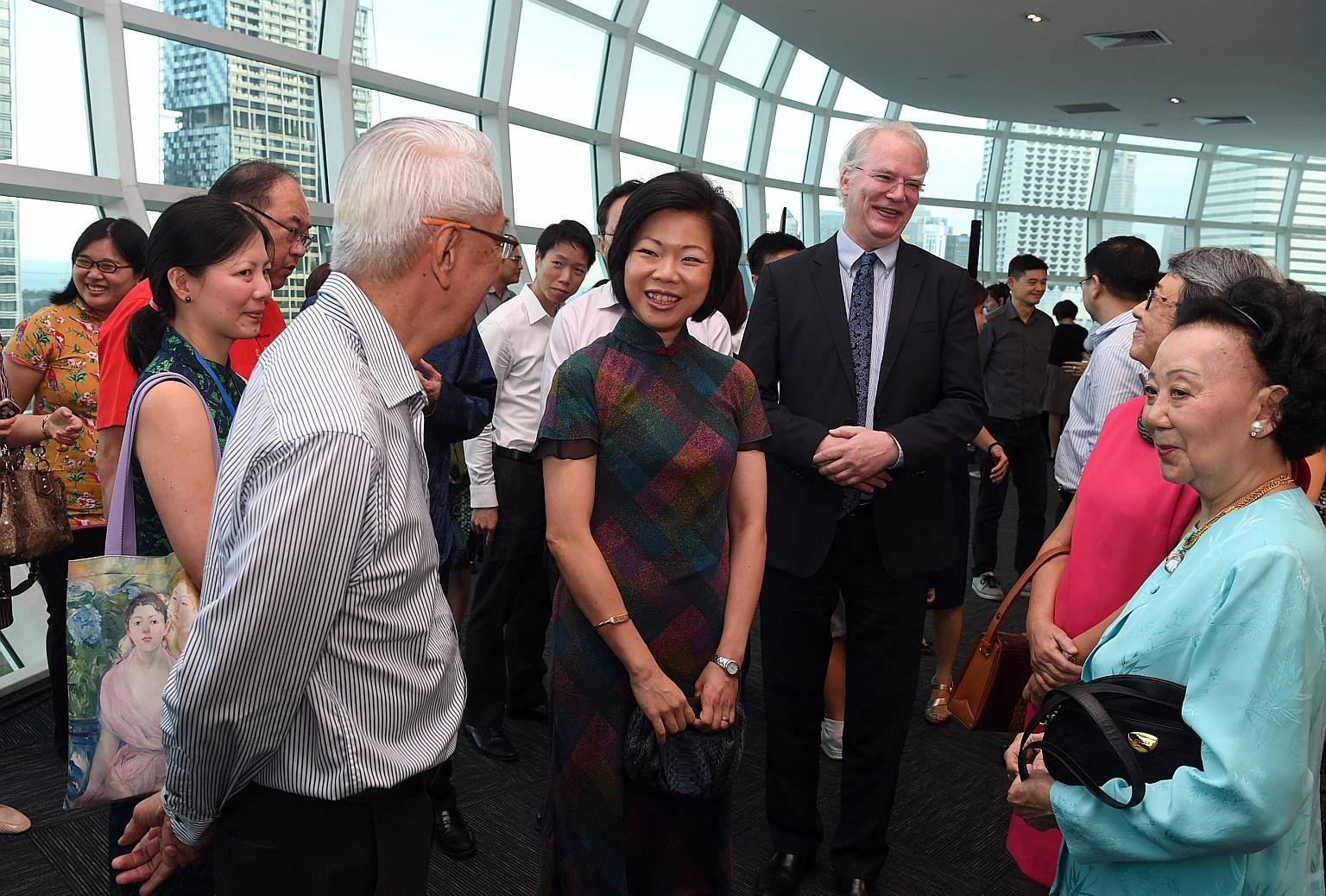 Senior Minister of State Sim Ann (centre) with Mr Robert Lim, a descendant of pioneer Lim Nee Soon, as well as Ms Katherine Hoo (far right), a descendant of pioneer Whampoa Hoo Ah Kay, at the launch of the database yesterday. Also present was NUS Dep