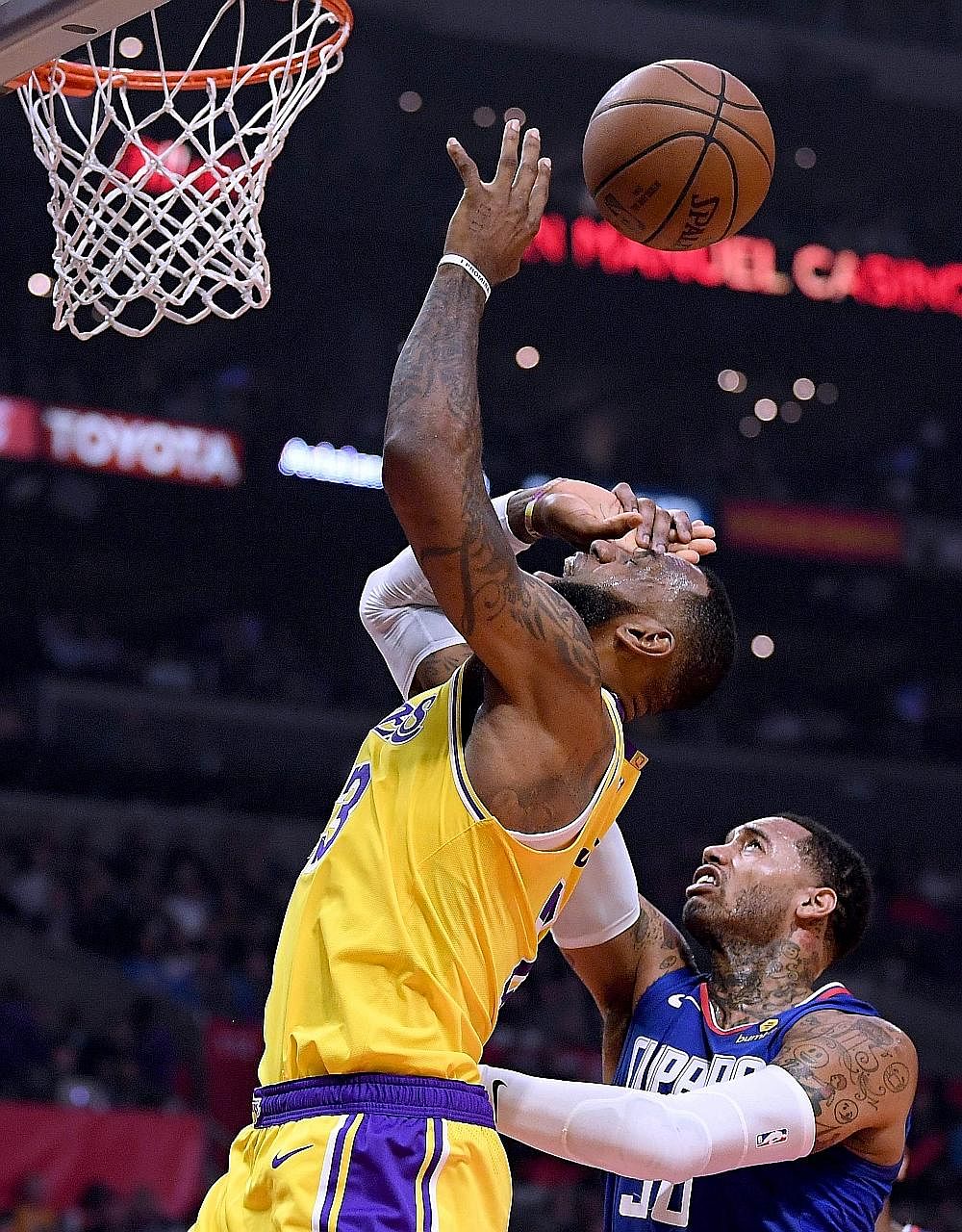 LeBron James being fouled by the Clippers' Mike Scott in the first half at Staples Centre on Thursday. The Los Angeles Lakers forward made a triumphant return after 36 days on the sidelines, leading his team to a 123-120 overtime win over the Clipper