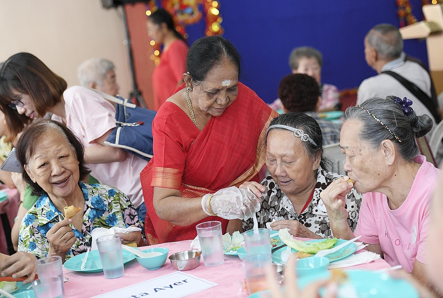 Chinese New Year took on a multicultural flavour yesterday when Singapore's oldest Hindu temple opened its doors for its annual celebration, complete with a lion dance and hongbao distributions. Temple volunteer Ayyavoo Sulochana (in red sari), 76,
