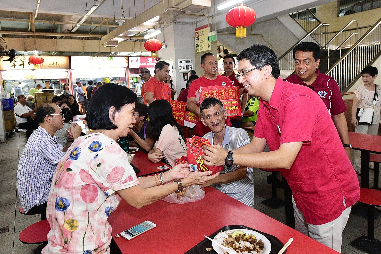 Some patrons of Chinatown Complex Food Centre yesterday received oranges from volunteers from the People's Association Malay Activity Executive Committees Council (Mesra), led by Senior Parliamentary Secretary for Social and Family Development and Ed