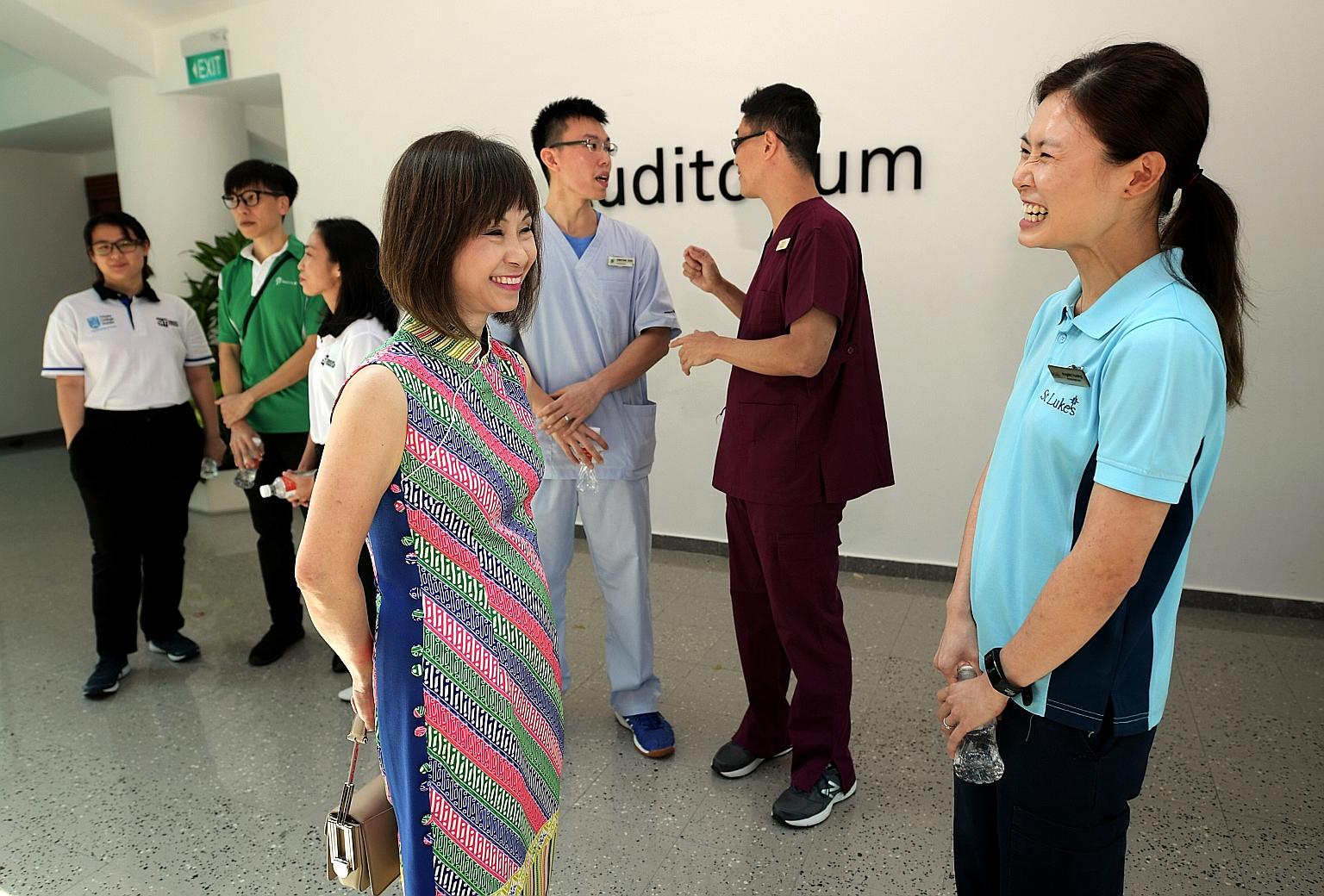 Senior Minister of State for Health Amy Khor speaking to Ms Angela Huang, who successfully made a mid-career switch to become a physiotherapist, at the launch of the new degree programme at Singapore Institute of Technology yesterday.