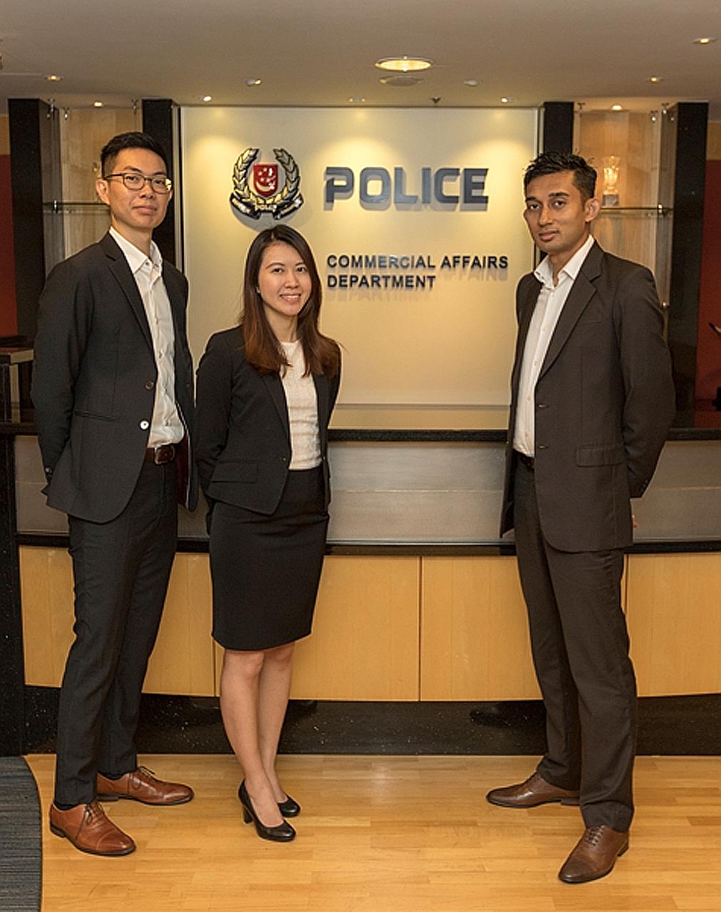Commercial Affairs Department officers (from far left) Wong Kean Yong, Tan Ruiyunand Muhammad Imran Mohamad Ayub. The trio helped to recover the ill-gotten proceeds that had been parked here.