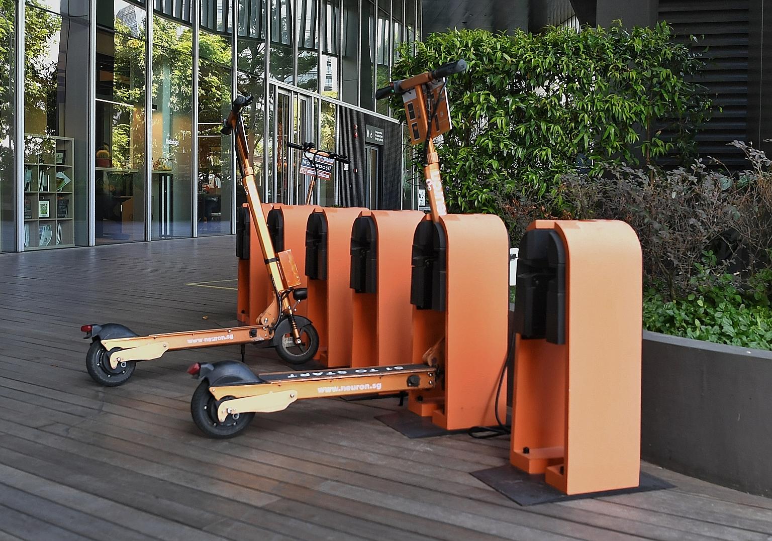 Neuron Mobility's e-scooters parked outside the Ascent building in Science Park Drive yesterday. The Singapore-based firm is one of 14 vying for a personal mobility device-sharing licence from the LTA.