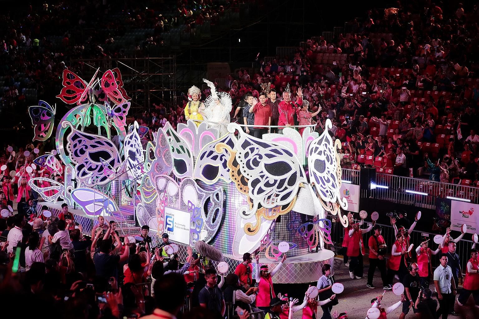 Prime Minister Lee Hsien Loong and Mrs Lee stood atop a butterfly-themed float on the first night of the two-day Chingay parade at the F1 Pit Building yesterday, as they joined in the festivities. The theme for this year's edition of the annual stree