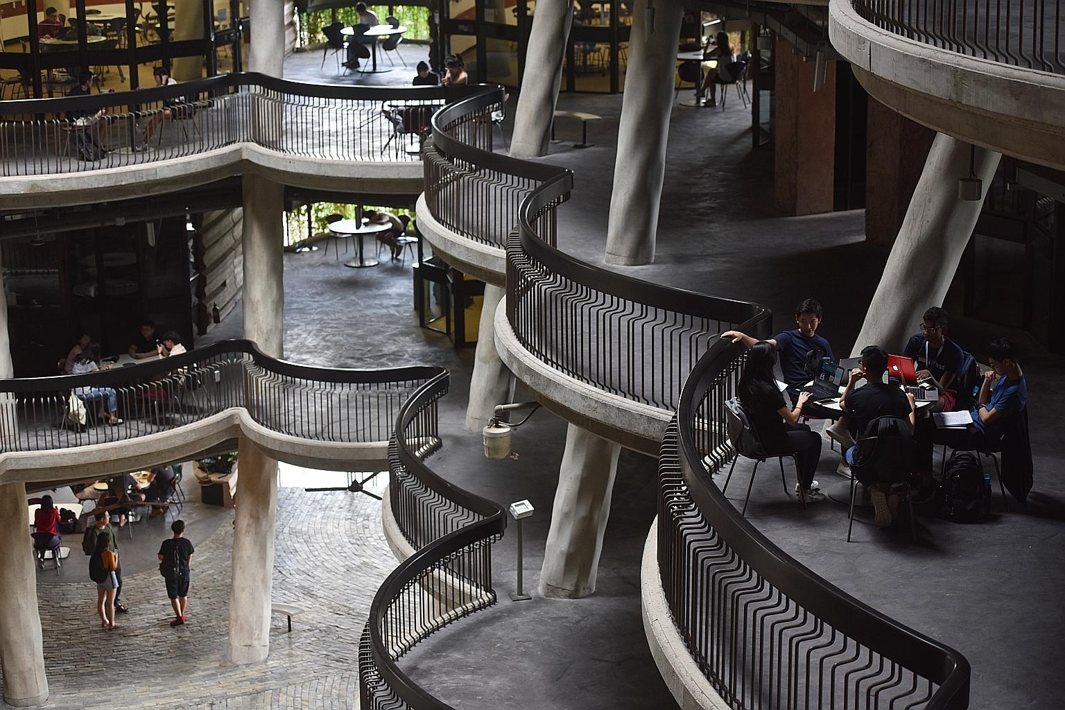 Students at The Hive in Nanyang Technological University. NTU said the 40 programmes adopting the broader criteria this year include those in humanities and social sciences, engineering, and science.