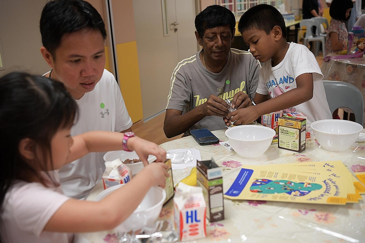 Children preparing breakfast for their fathers at an event at Yu Neng Primary School yesterday.
