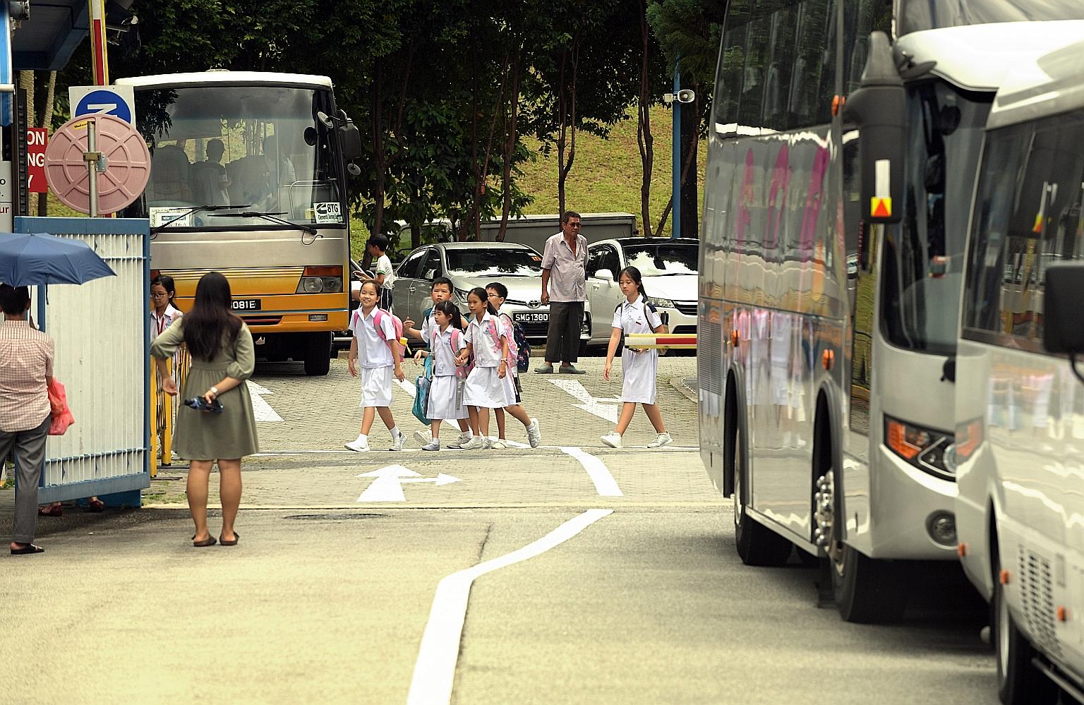 Pei Hwa Presbyterian Primary School pupils on their way to school. Singaporean primary and secondary school students will receive a $150 top-up to their Edusave accounts this year, in addition to the yearly contributions.