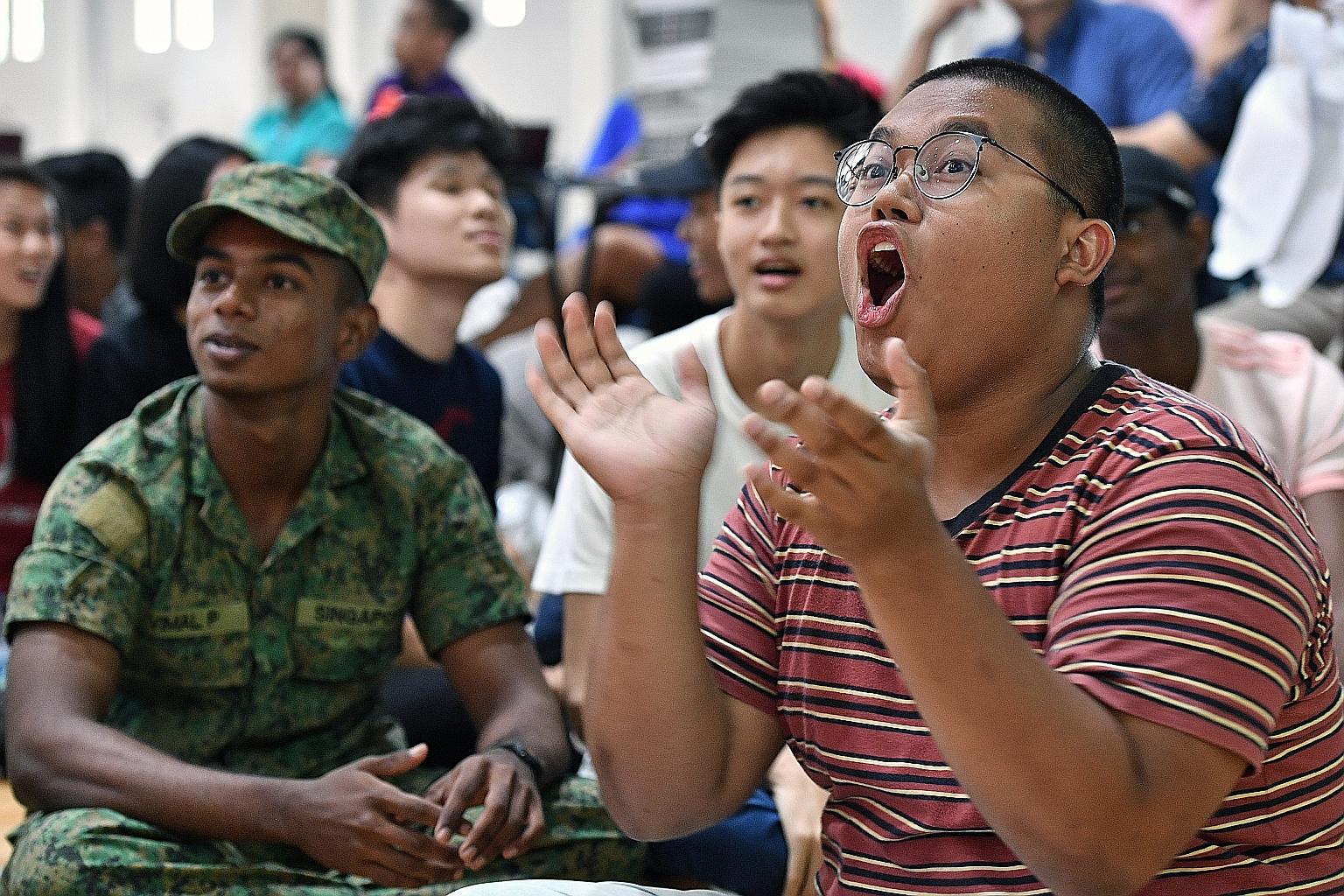 Muhammad Nur Izeyar Yazid (right) and Vimal P (in army uniform) were among four students singled out yesterday for their exemplary character by Ms Britta Seet, vice-principal of Jurong Pioneer JC.