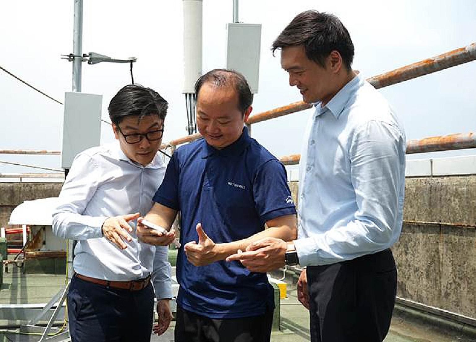 Singtel engineers in Singapore using the Oppo 5G test device during the three-minute 5G video call with their Optus counterparts in Sydney.