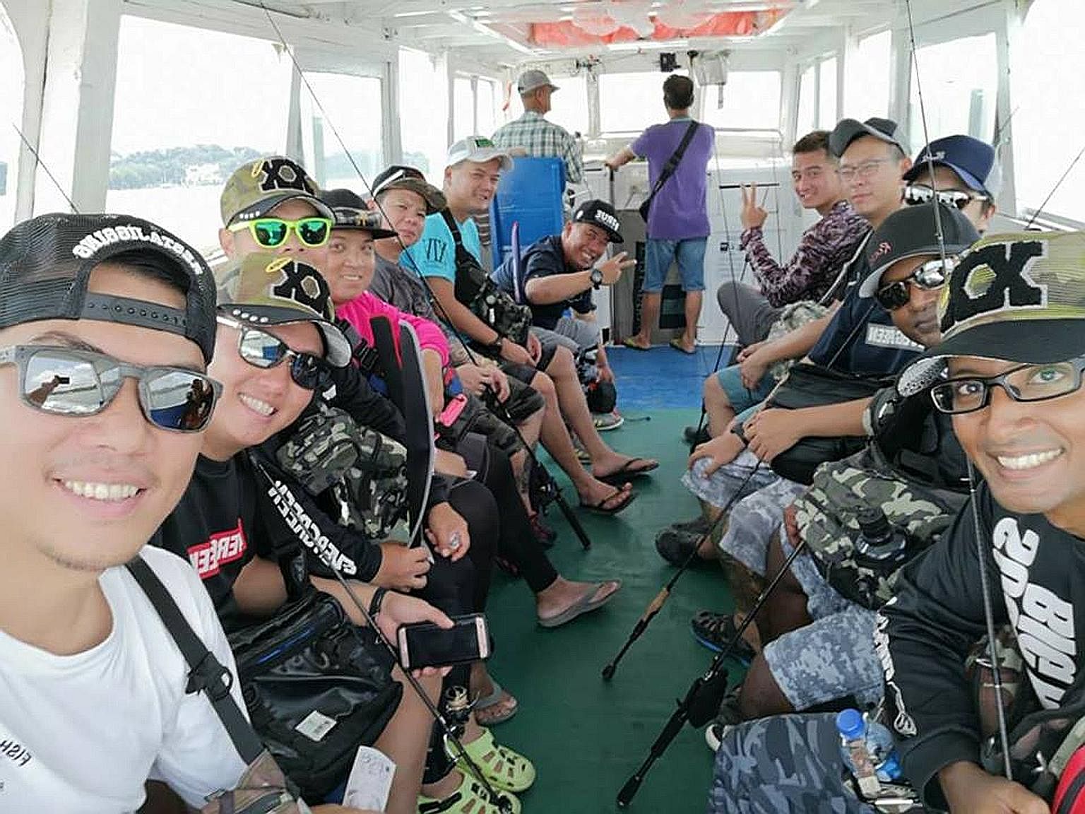Mr Billy Tan (above, left) on a fishing trip to Pulau Ubin with his friends. The fishing enthusiast who has been visiting Pulau Ubin once a week in the past four years said he was put off by new fences put up around the island, which once had "many g