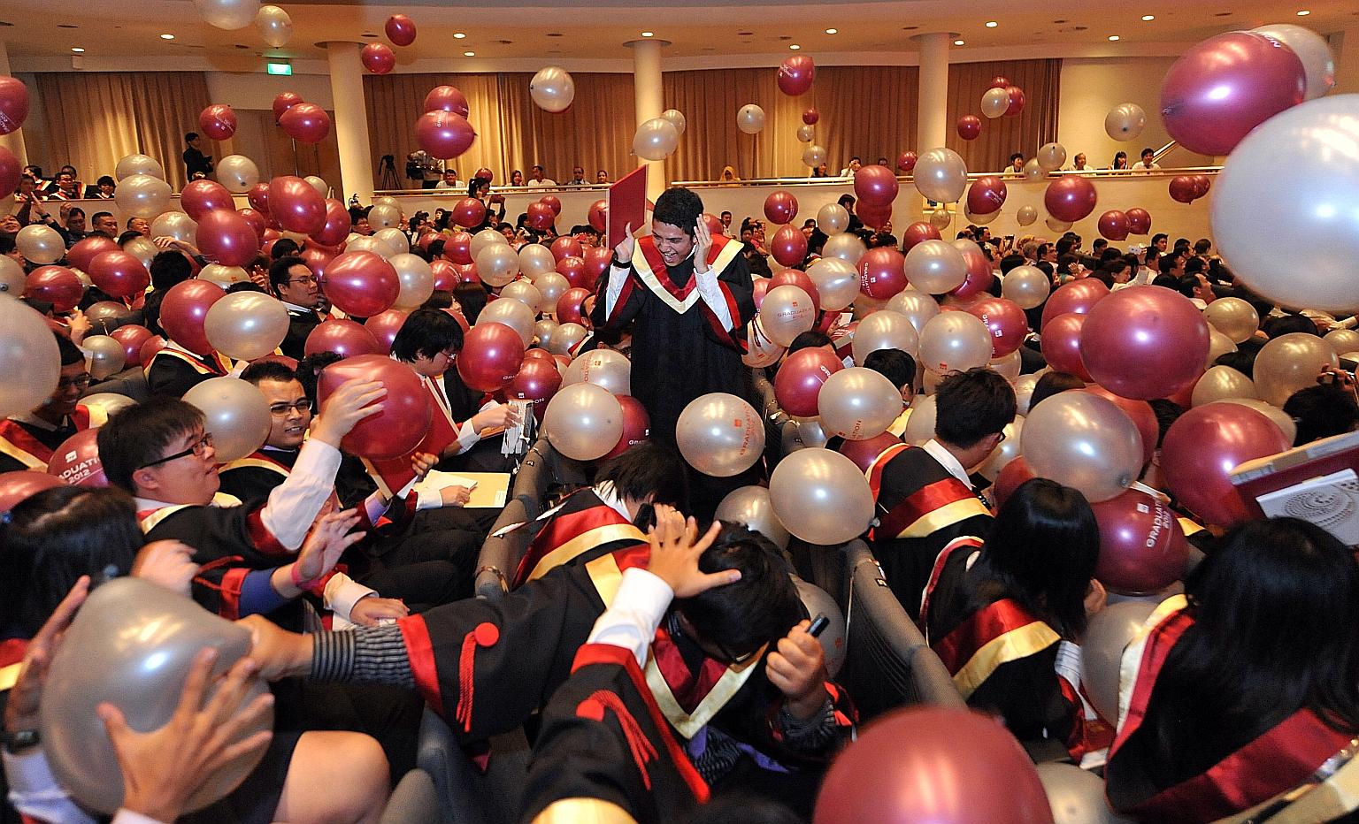 Institute of Technical Education (ITE) students celebrating at their graduation ceremony. Since 2015, the public service has been moving towards single salary schemes for officers, whether they are ITE or university graduates.