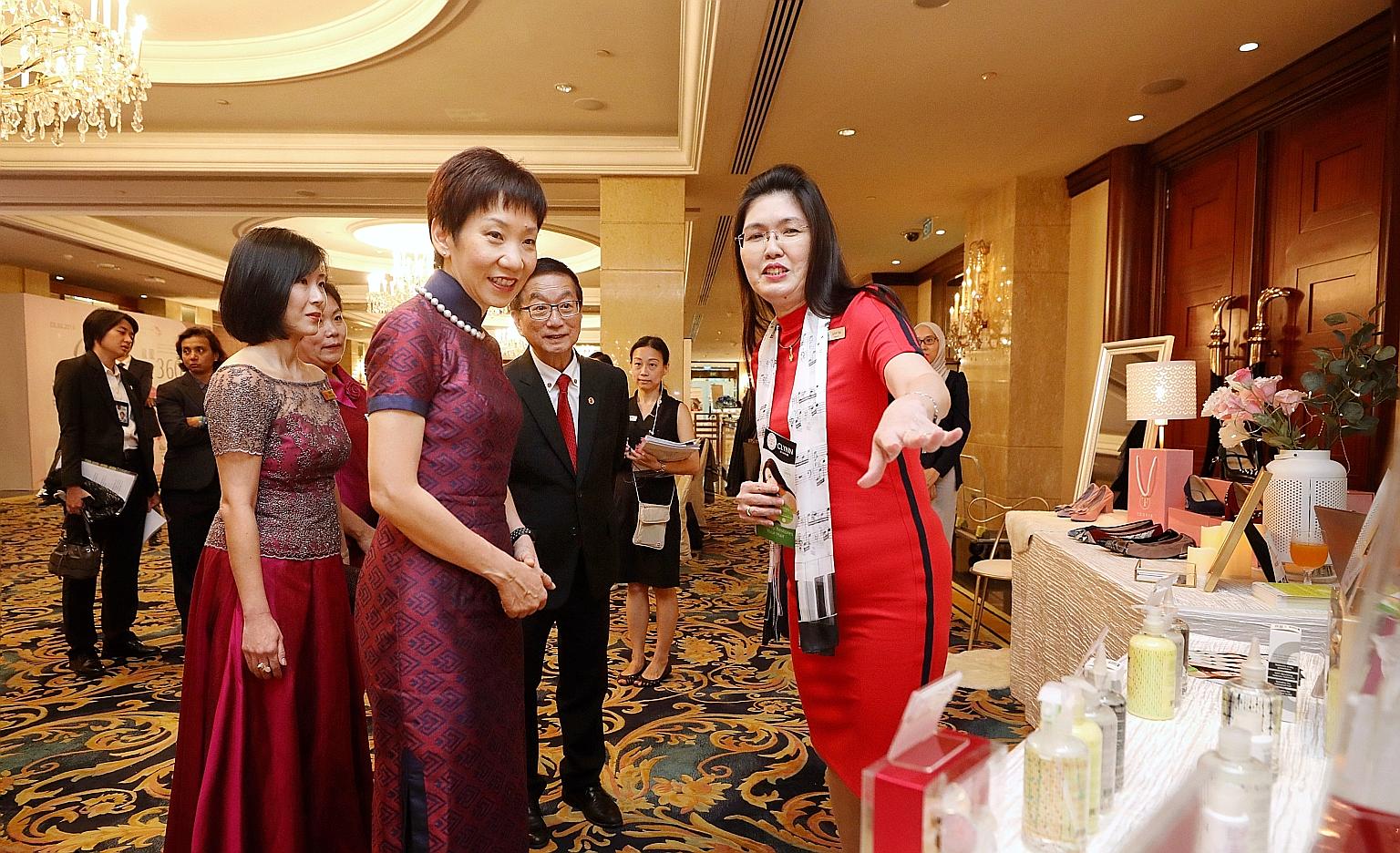 Minister for Culture, Community and Youth Grace Fu speaking to Ms Lynn Yap (right), founder of personal care products brand Clynn by Nature, at her booth at Marketplace by Crib yesterday. Crib is a non-profit group that helps build business networks