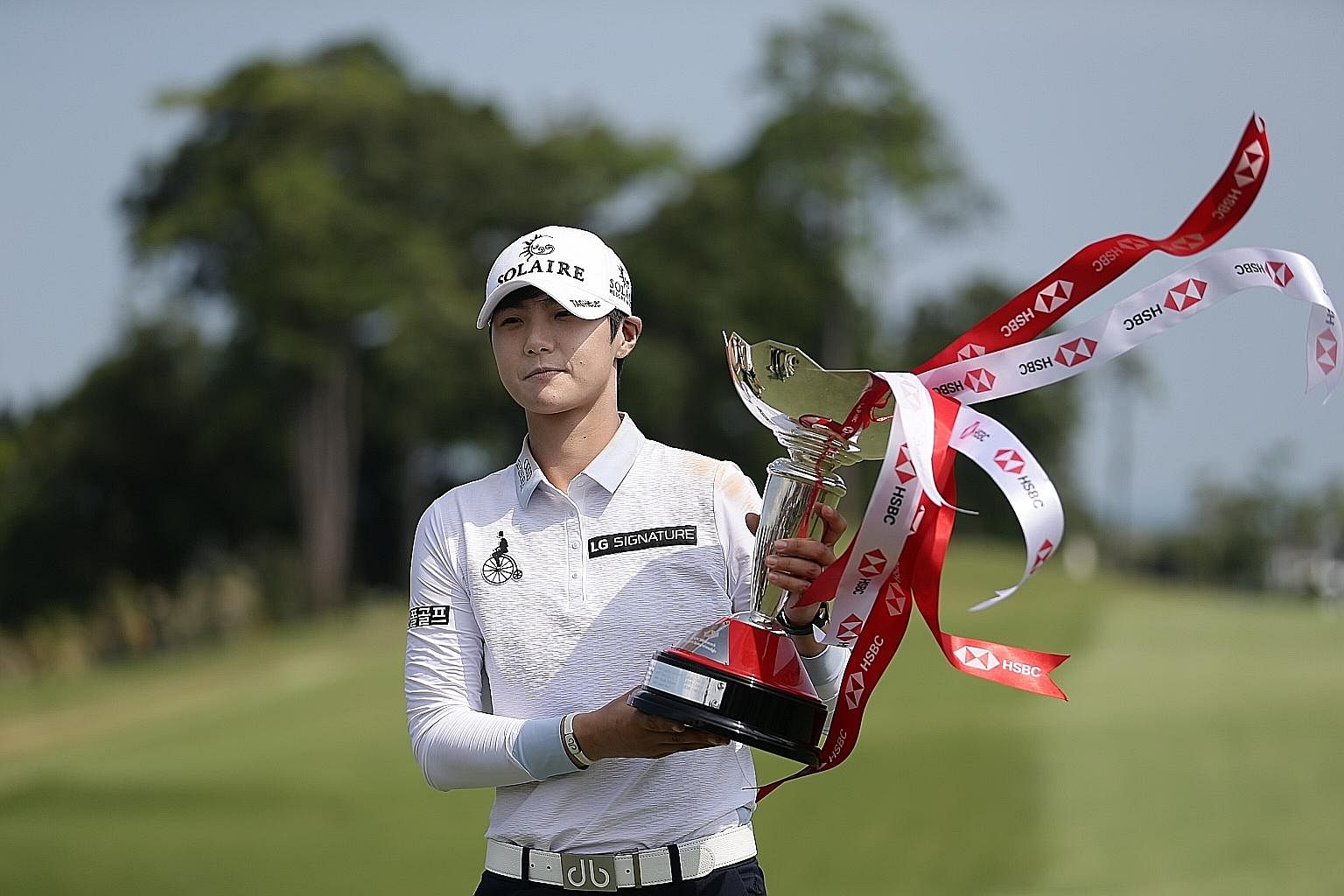 South Korean golfer Park Sung-hyun showing off her HSBC Women's World Championship trophy after firing an eight-under 64 in the final round at Sentosa Golf Club's New Tanjong Course yesterday. World No. 2 Park, 25, overcame a four-shot deficit to bea