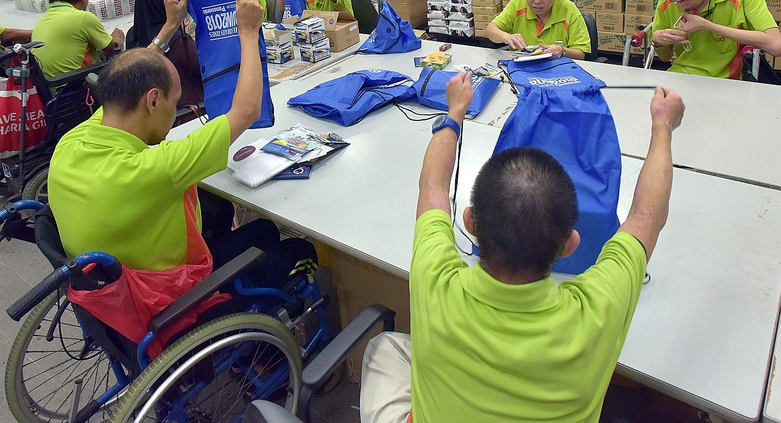 People from SPD, a charity for those with disabilities, packing bags for last year's ST Run. Ms Indranee Rajah said tertiary institutes help students with special needs build up their confidence and independence.