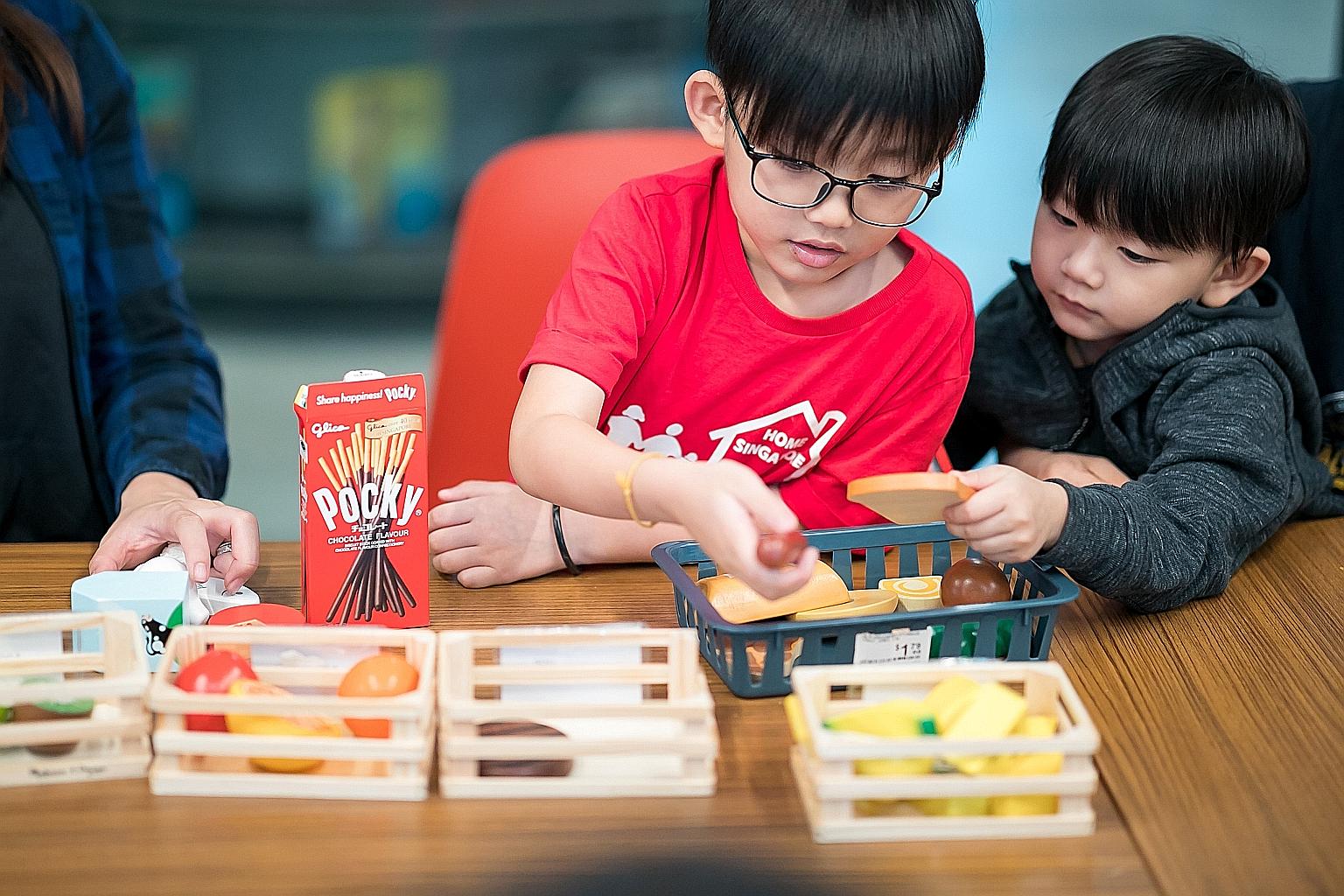 Children taking part in hands-on activities that teach computational thinking at a Tiny Thinkers workshop.