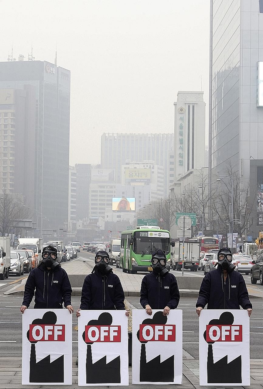 Protesters rallying in Seoul yesterday against the development of a coal mine. Large parts of South Korea are choking on air pollution.