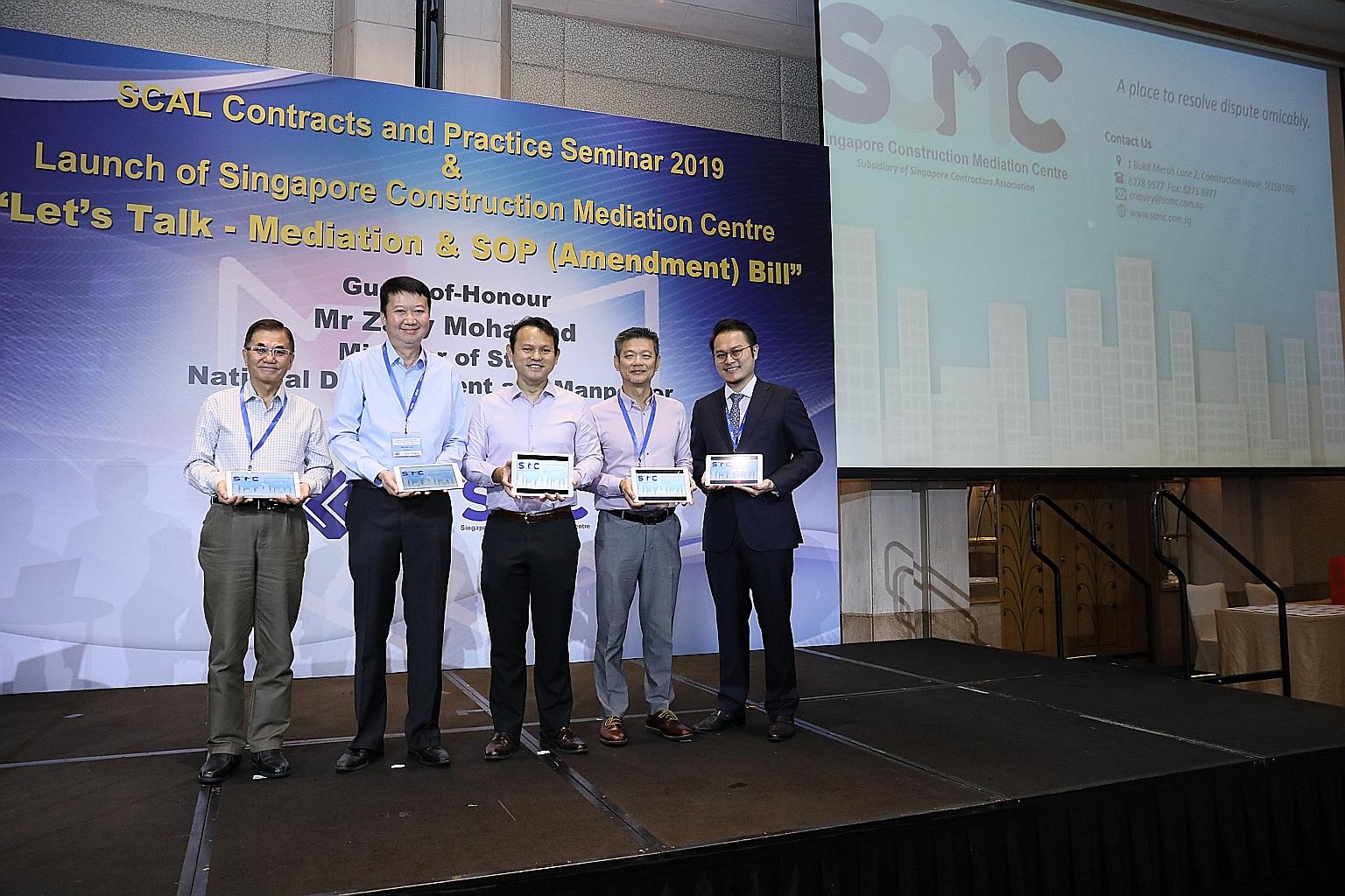 Marking the centre's launch yesterday were (from left) Singapore Construction Mediation Centre (SCMC) workgroup chairman Jason Tay, Singapore Contractors Association (SCAL) president Kenneth Loo, Minister of State for Manpower and National Developmen