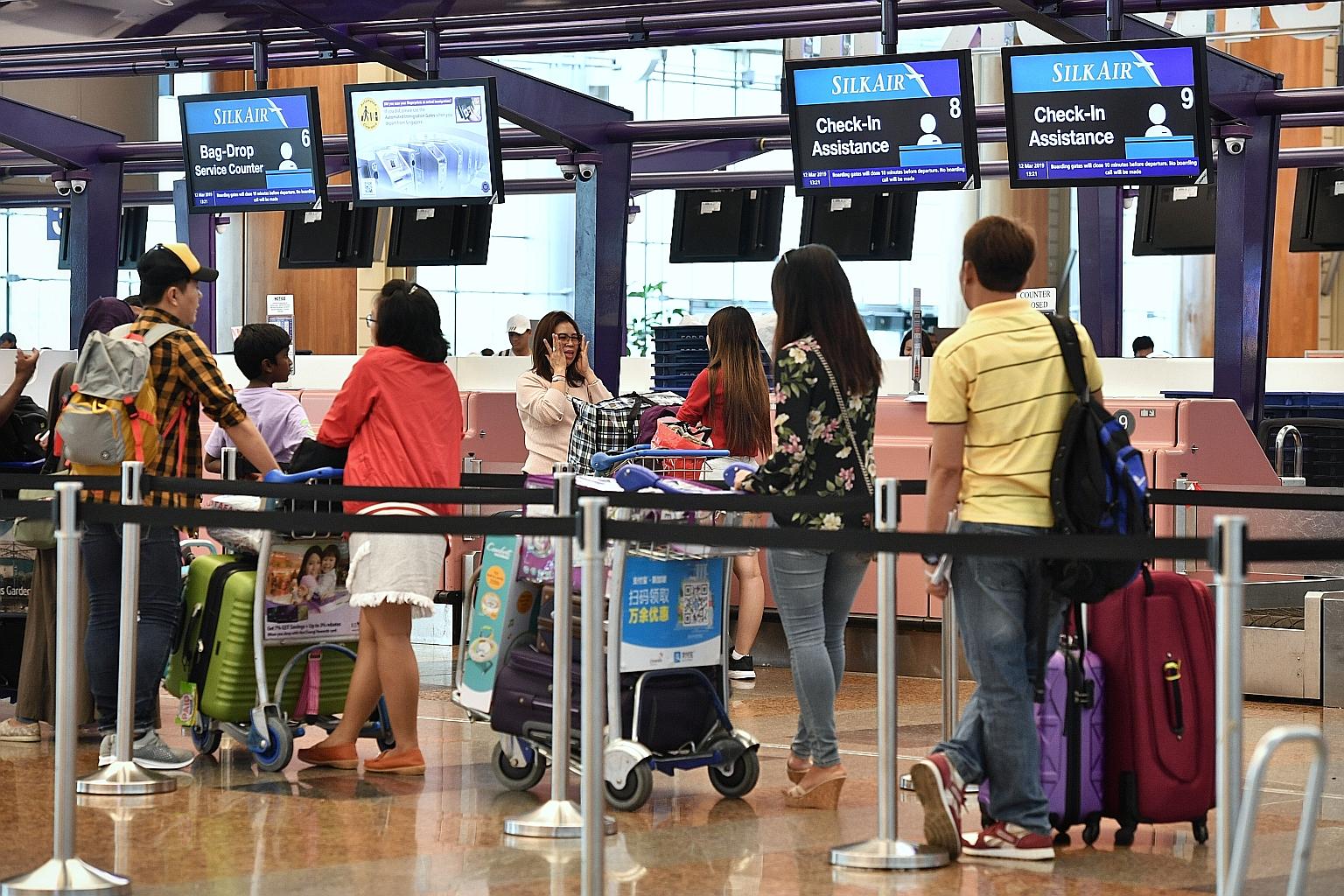 SilkAir passengers at Changi Airport Terminal 2 yesterday. The airline, which has six Boeing 737 Max 8 jets, is one of those at Changi affected by the temporary suspension. The Civil Aviation Authority of Singapore said it was suspending the aircraft